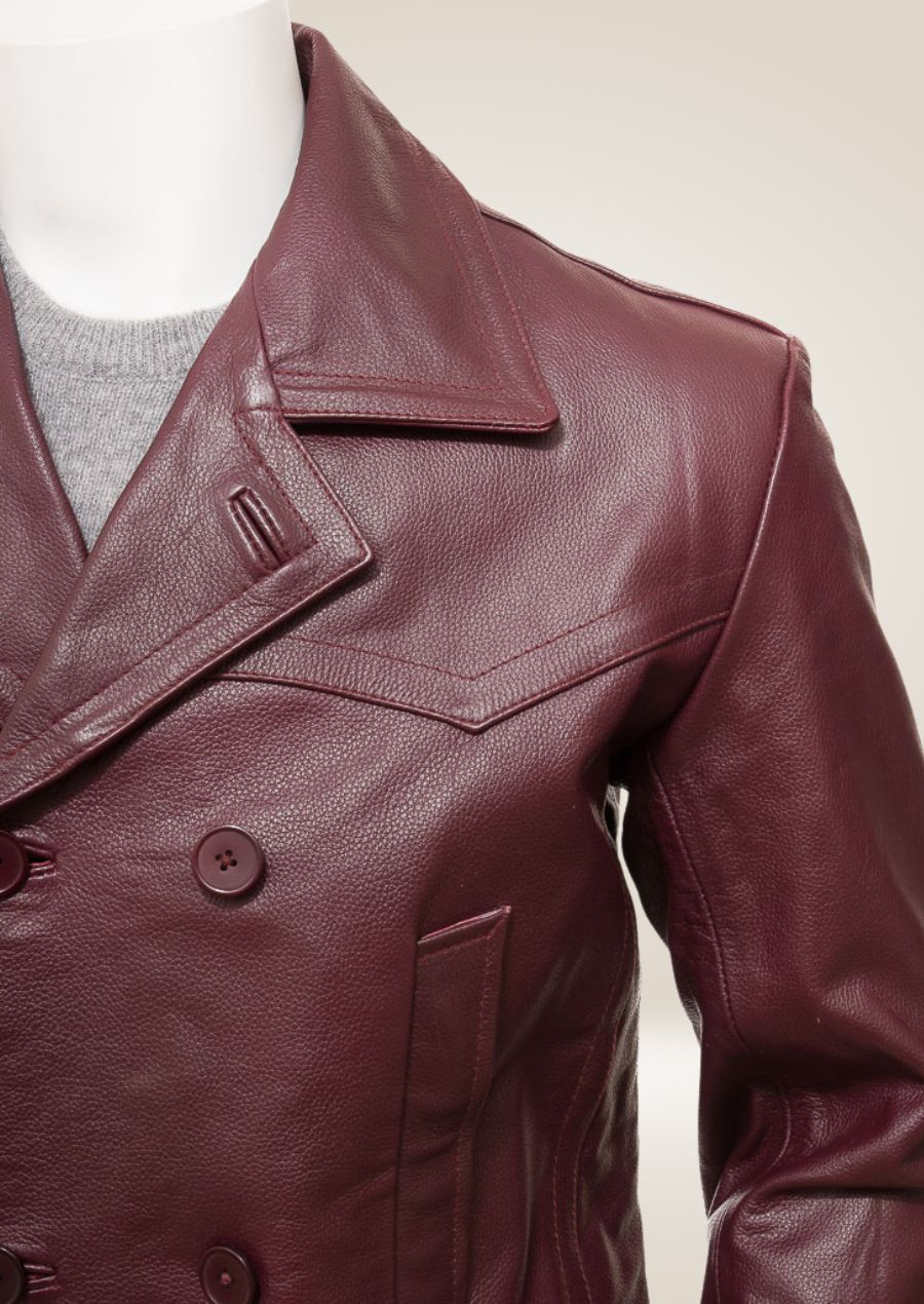 Close-up of the shoulder area of the men's burgundy pea coat, featuring precise stitching and a sharp, structured fit.